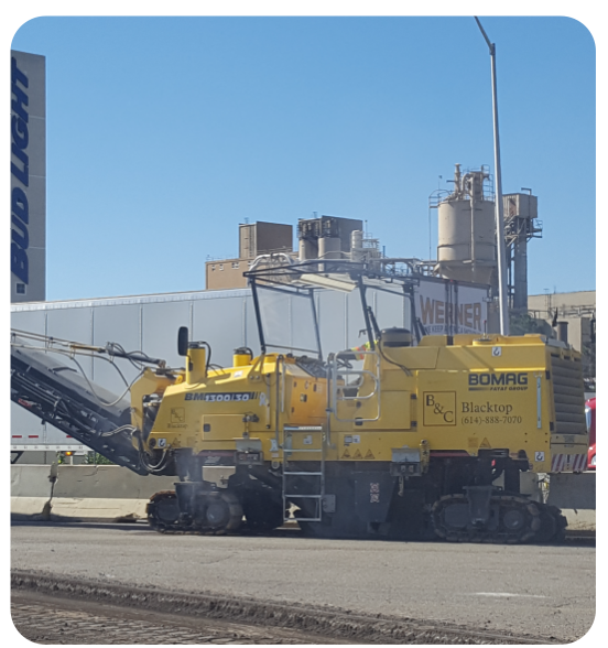 Commercial asphalt milling machine removing damaged pavement during a Columbus parking lot restoration project.