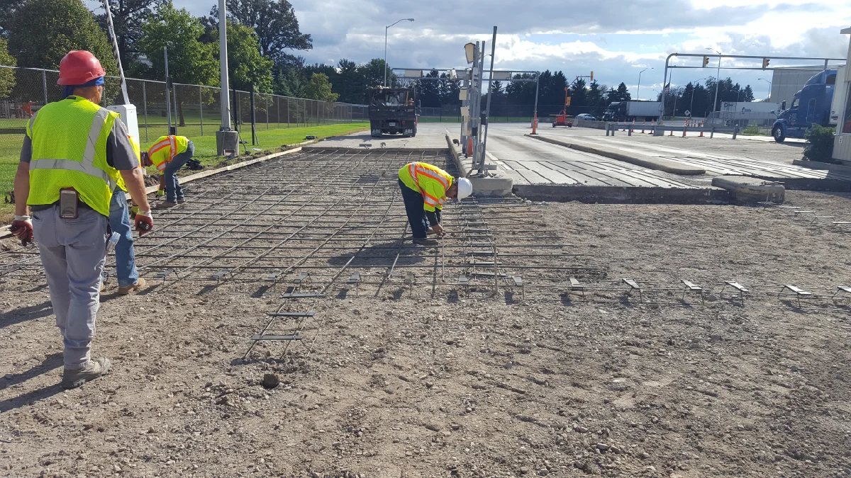 B&C Blacktop employee pouring concrete on jobsite