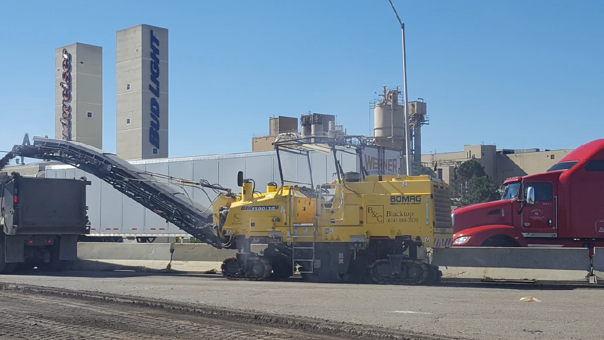 street repair with large asphalt equipment on jobsite